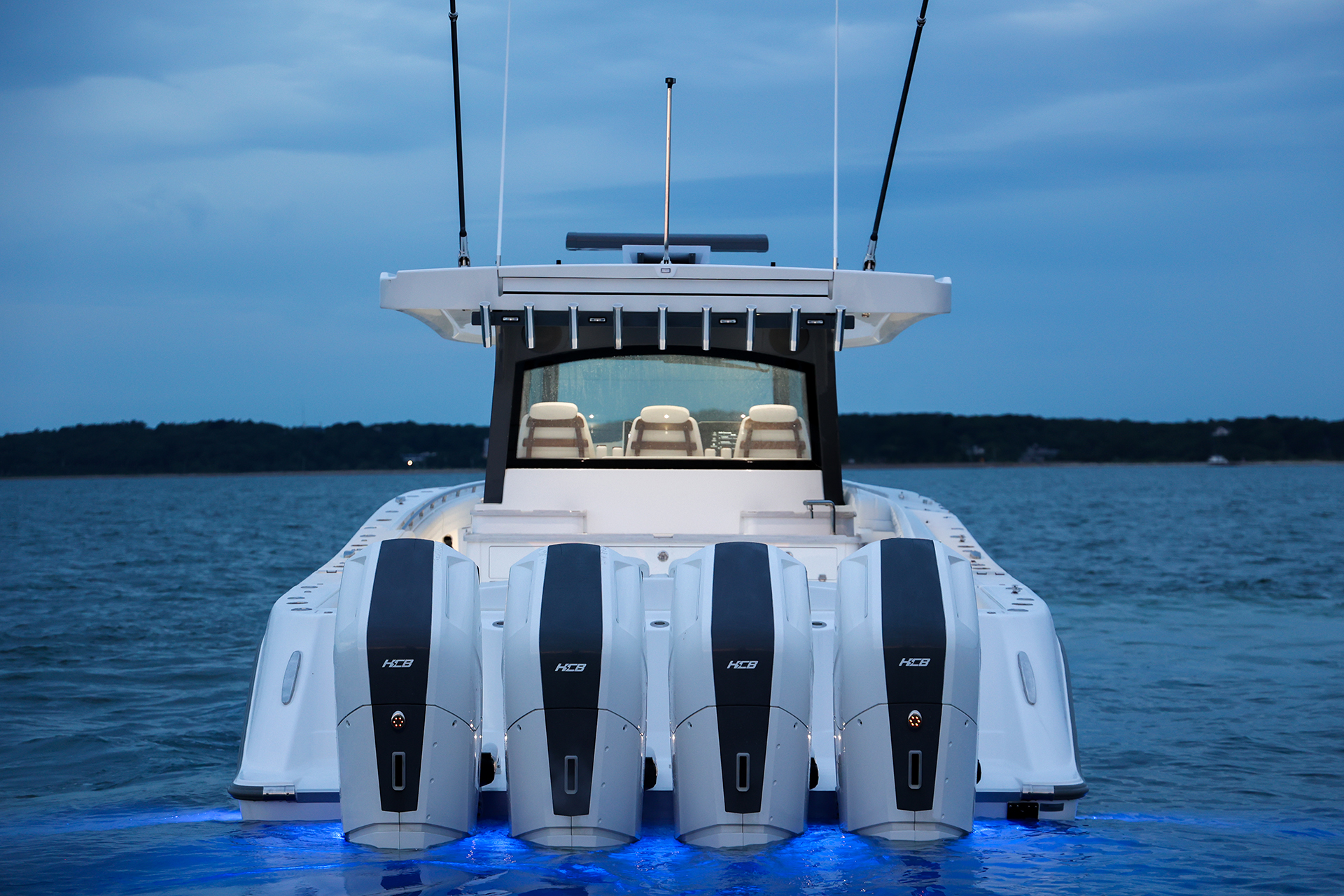 Quad outboards on the transom of a center console at dusk